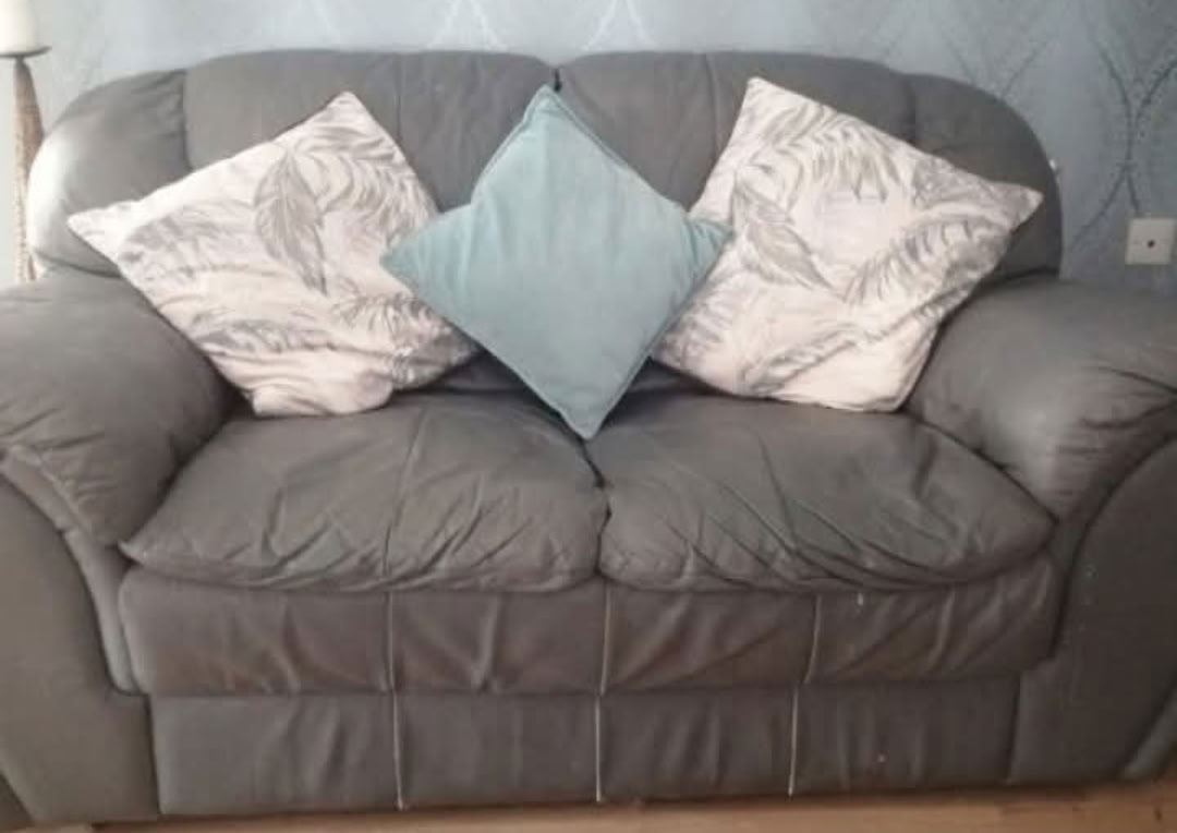 Grey leather sofa and pouffee