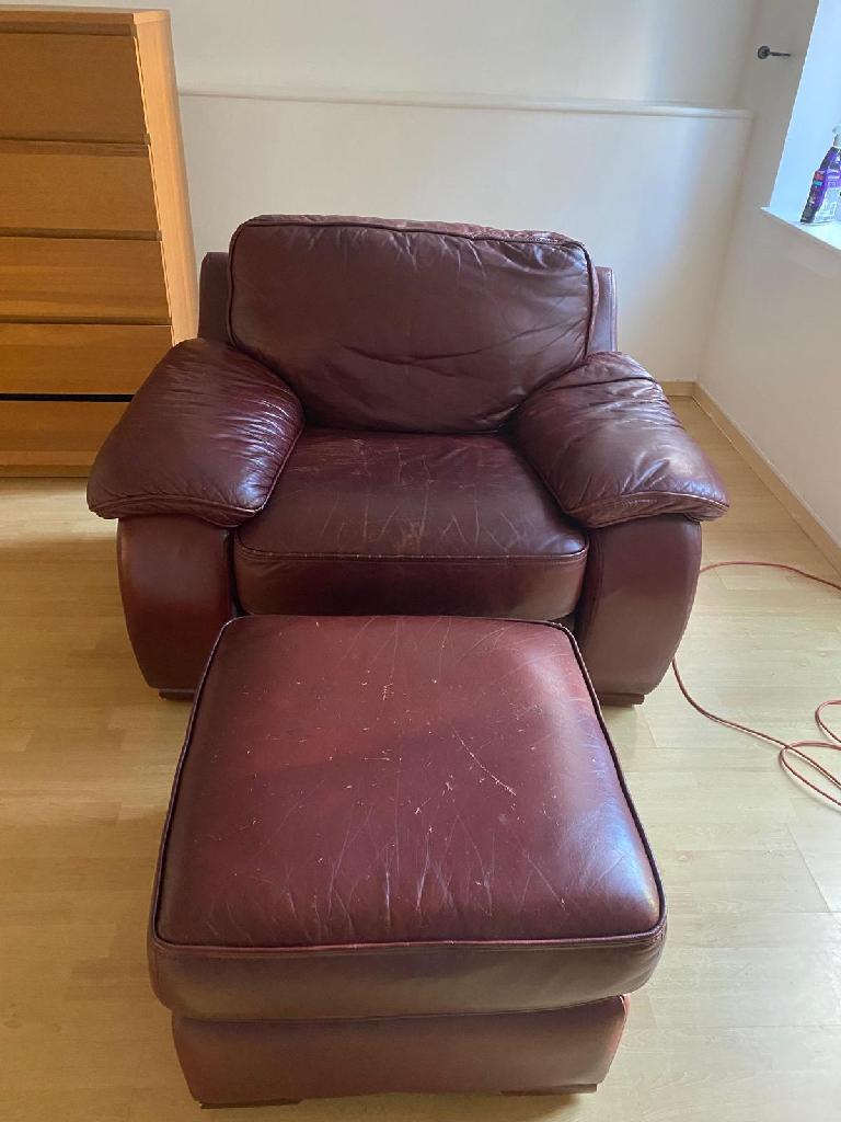 Red single leather sofa with foot stool. Very comfortable.